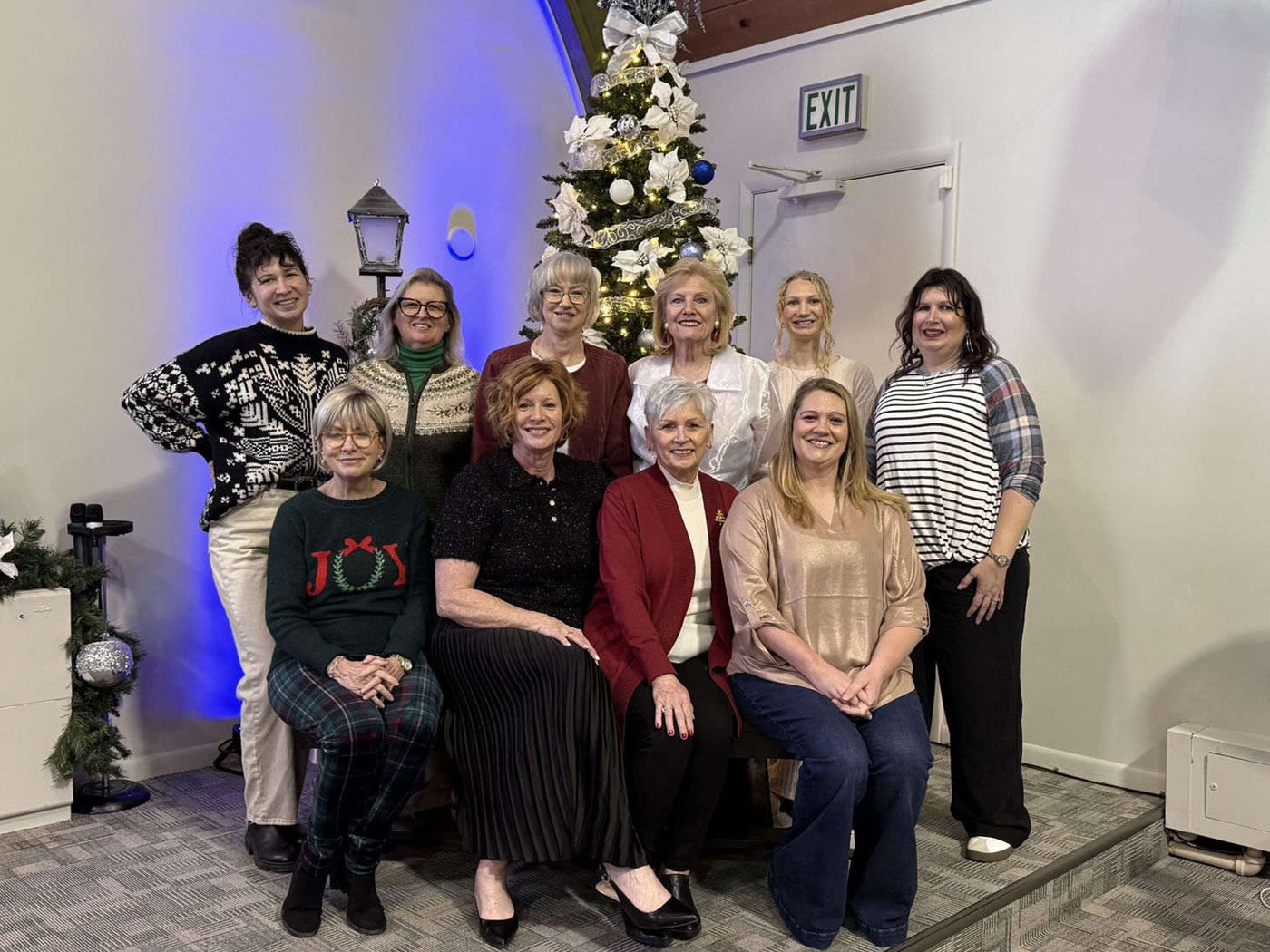 A team of women from the church family gathered in front of the Christmas tree